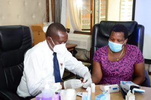 Director, HRM&D, Ms Mary Kemunto, being tested in the Blood Sugar category during the sensitization